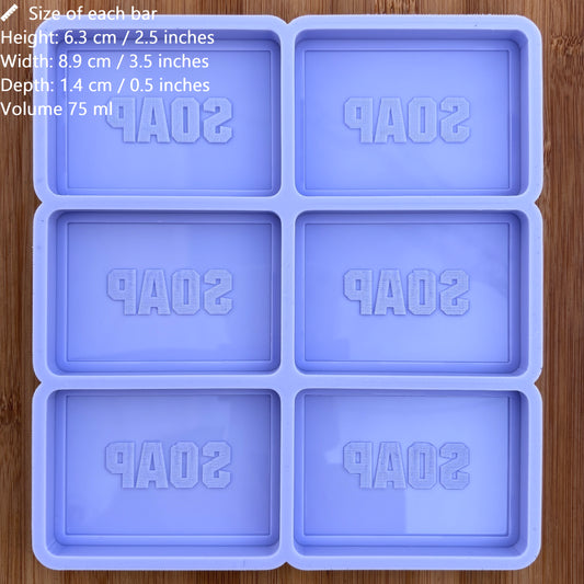 Silicone soap mold with 'SOAP' text on a wooden surface