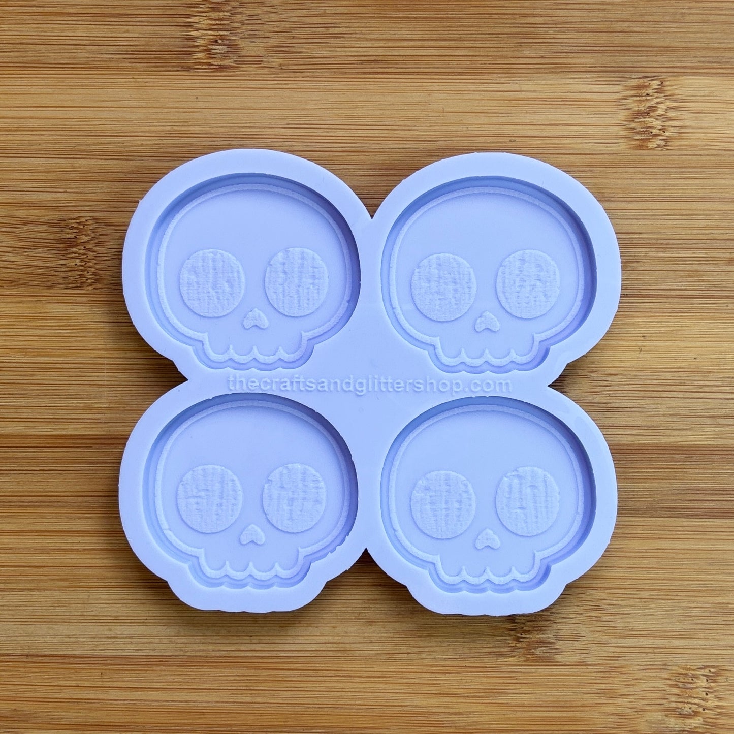 Cute Skull Silicone Mold with 4 cavities of 2 inches each, made from food safe silicone. Oven and freezer safe.