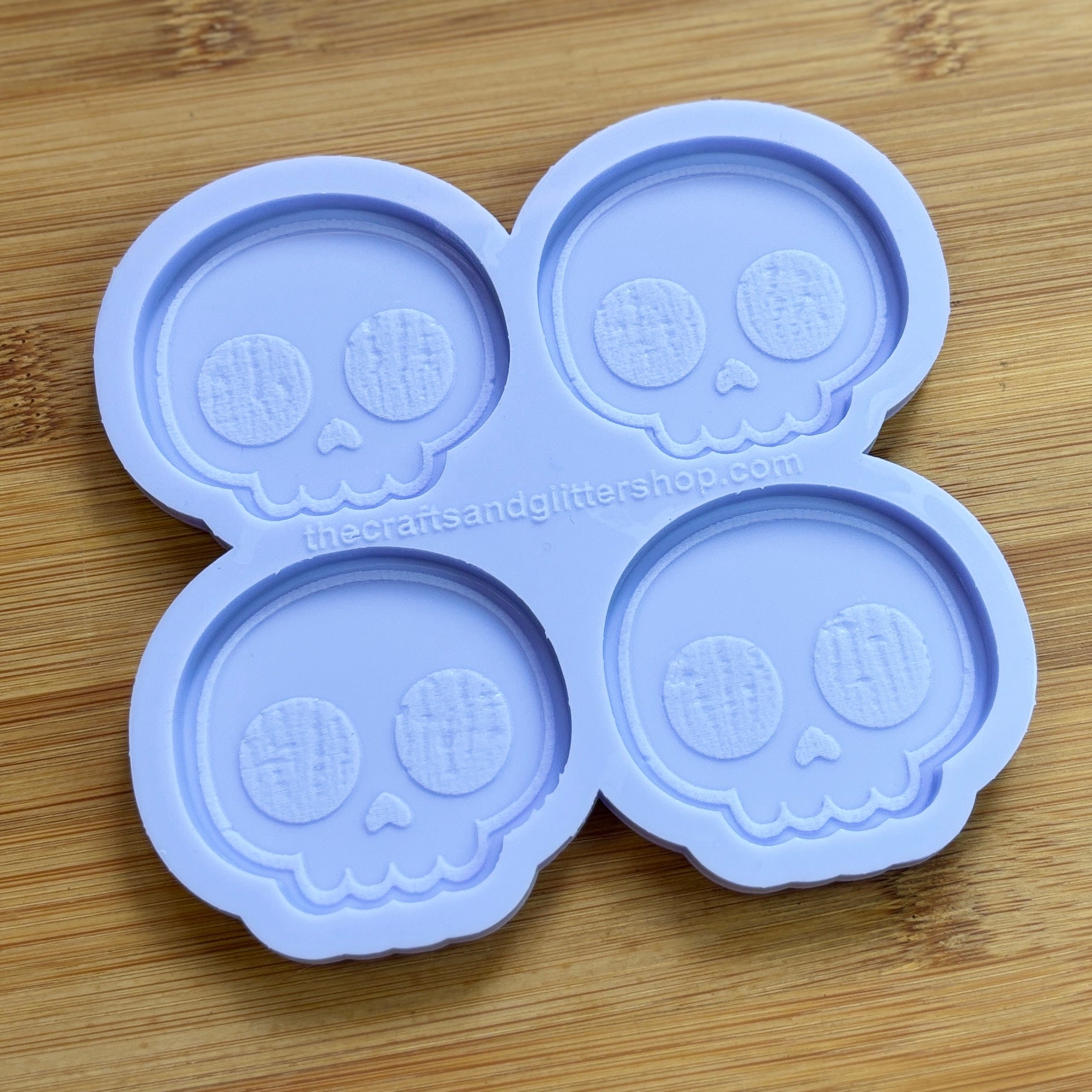 Cute Skull Silicone Mold with 4 cavities of 2 inches each, made from food safe silicone. Oven and freezer safe.