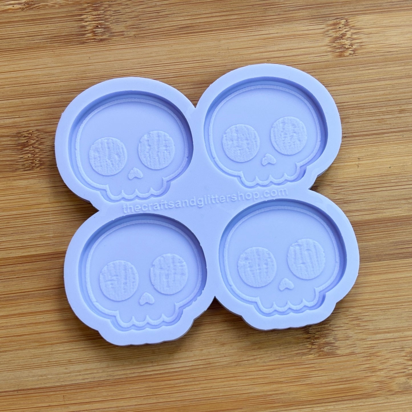 Cute Skull Silicone Mold with 4 cavities of 2 inches each, made from food safe silicone. Oven and freezer safe.