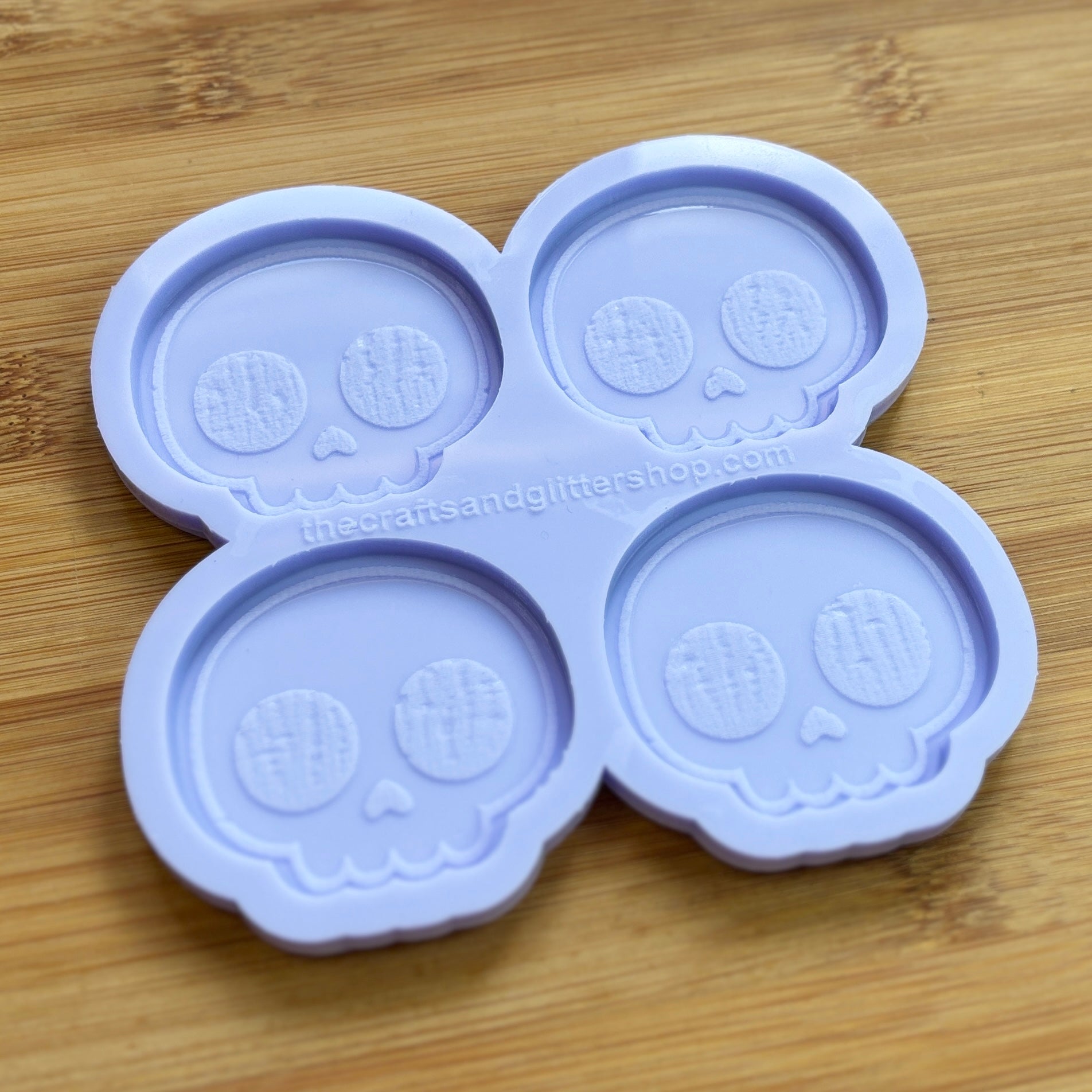 Cute Skull Silicone Mold with 4 cavities of 2 inches each, made from food safe silicone. Oven and freezer safe.