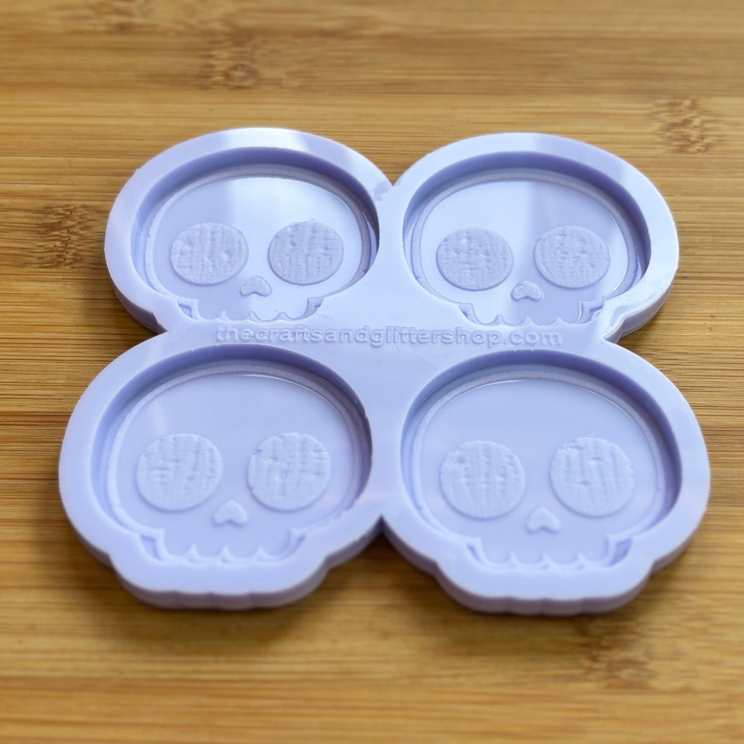 Cute Skull Silicone Mold with 4 cavities of 2 inches each, made from food safe silicone. Oven and freezer safe.
