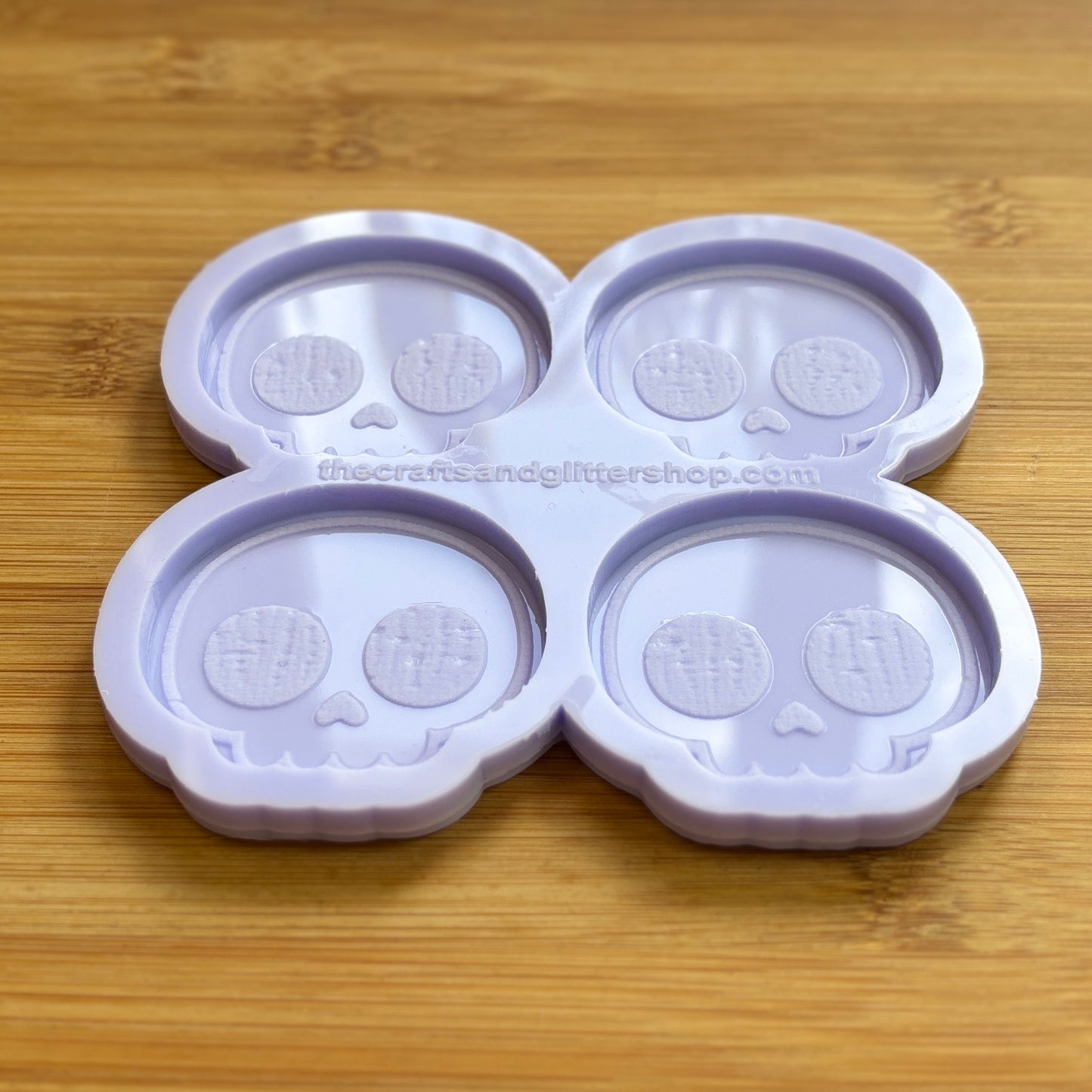 Cute Skull Silicone Mold with 4 cavities of 2 inches each, made from food safe silicone. Oven and freezer safe.