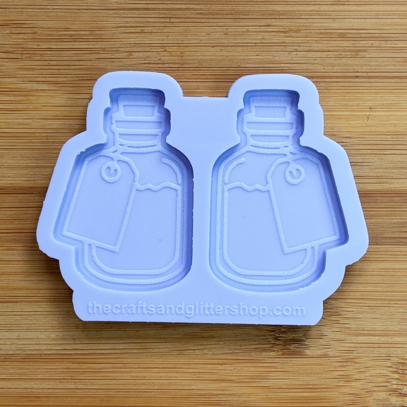 Silicone mold with bottle shapes on a wooden surface