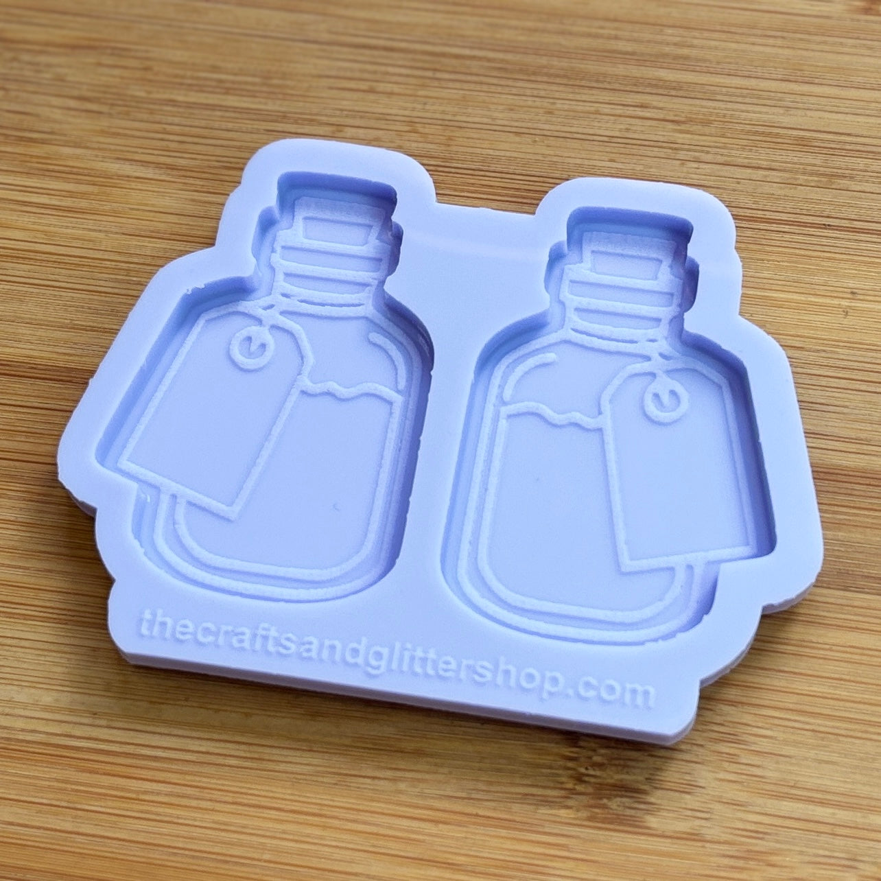 Silicone mold shaped like bottles on a wooden surface