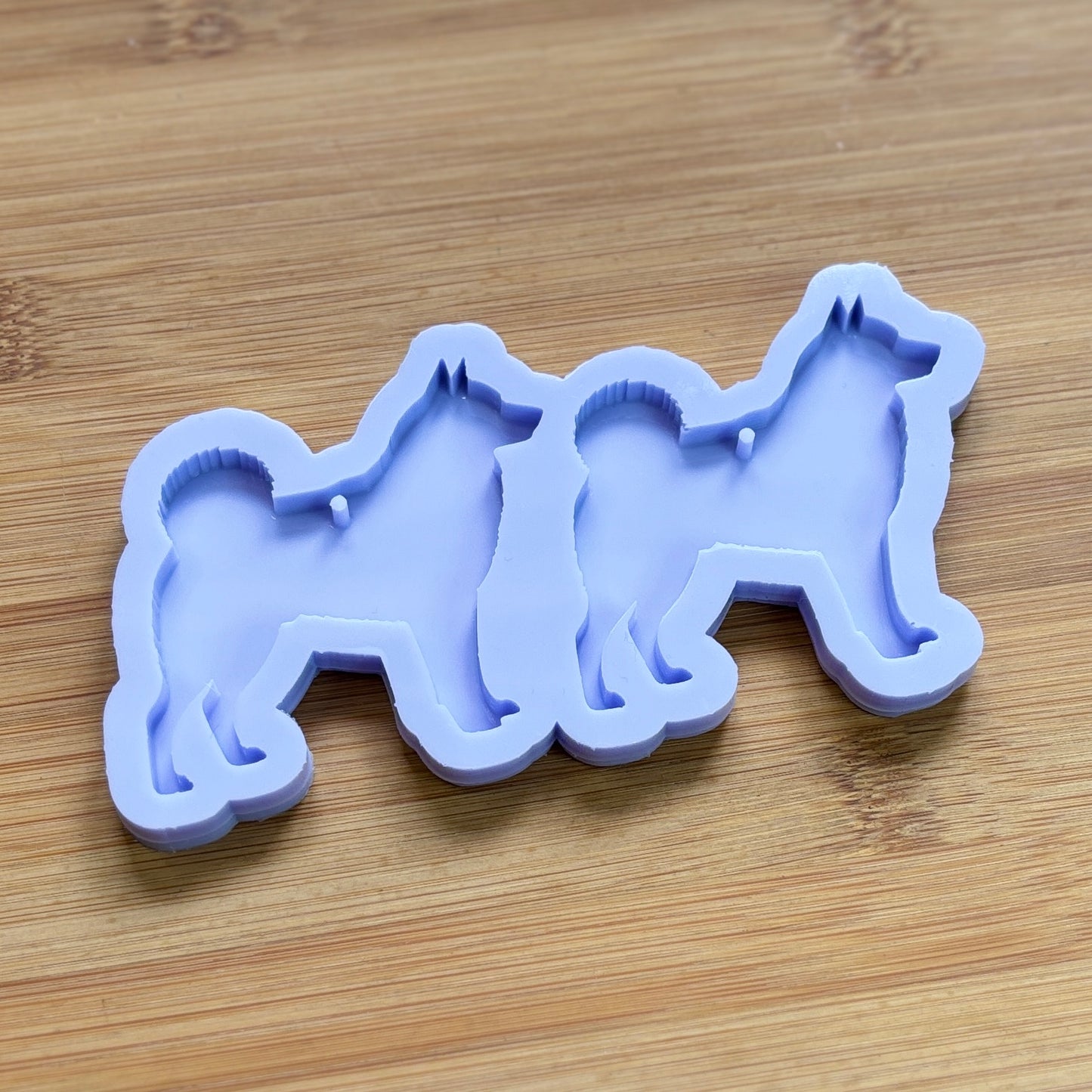 Norwegian Elkhound Silhouette Silicone Mold with 2 cavities, made with Food Safe Silicone suitable for both food and craft projects.