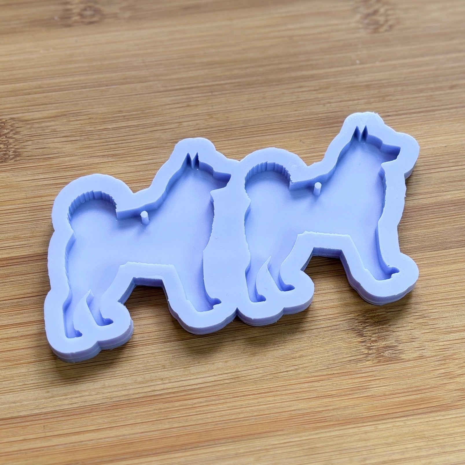 Norwegian Elkhound Silhouette Silicone Mold with 2 cavities, made with Food Safe Silicone suitable for both food and craft projects.