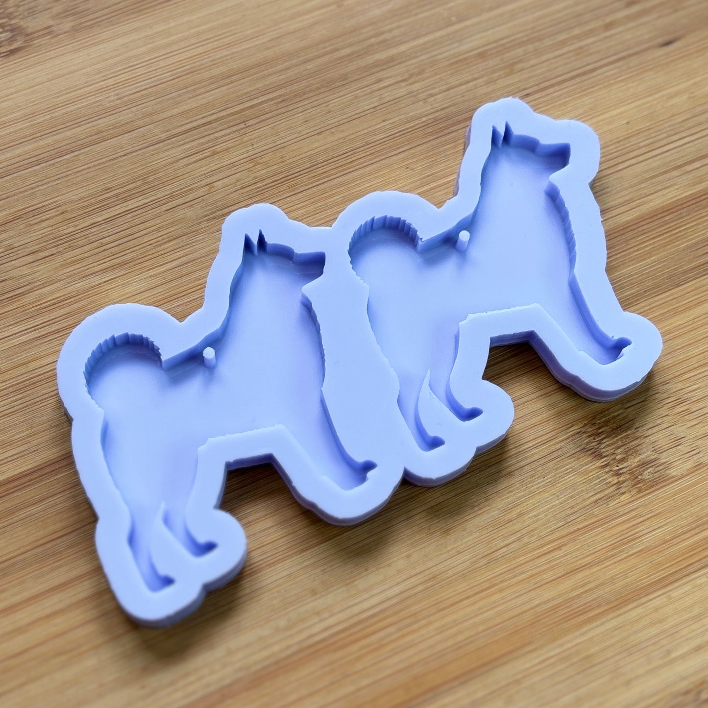 Norwegian Elkhound Silhouette Silicone Mold with 2 cavities, made with Food Safe Silicone suitable for both food and craft projects.