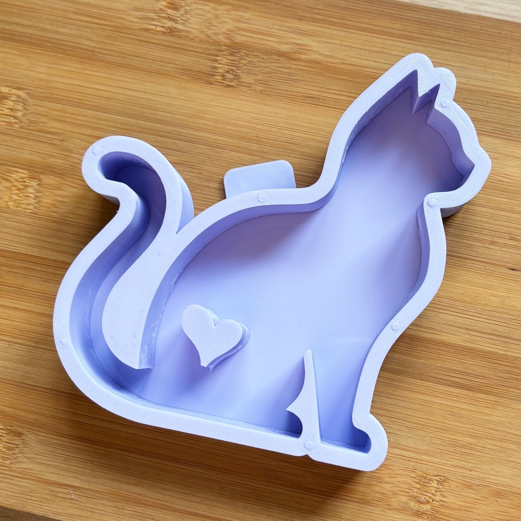 Cat-shaped silicone mold on a wooden surface