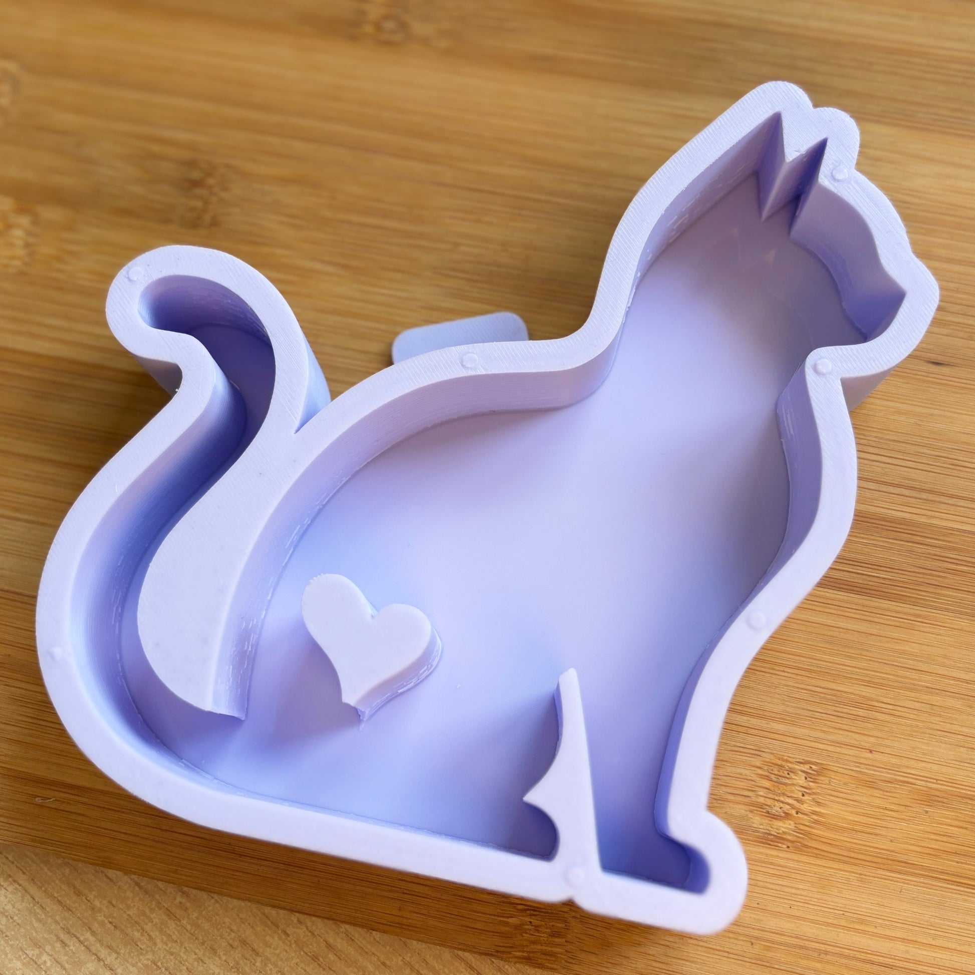 Cat-shaped silicone mould on a wooden surface
