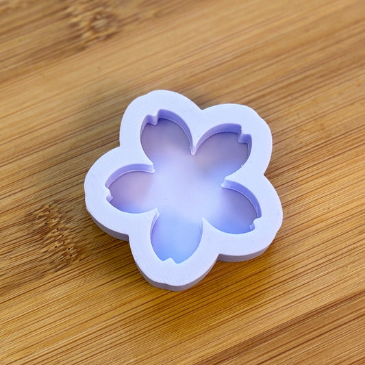 Flower-shaped silicone mold on a wooden surface