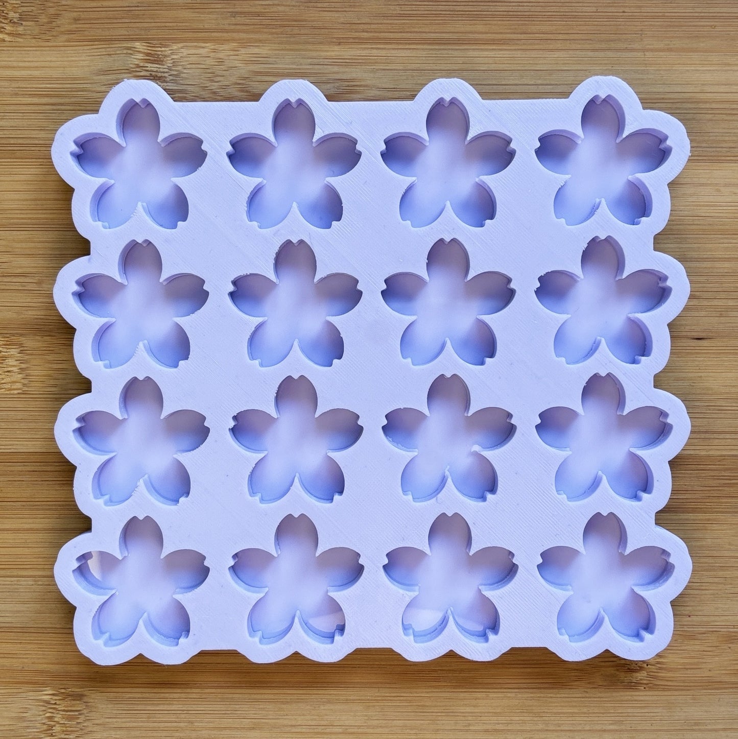 Flower-shaped silicone mold on a wooden surface