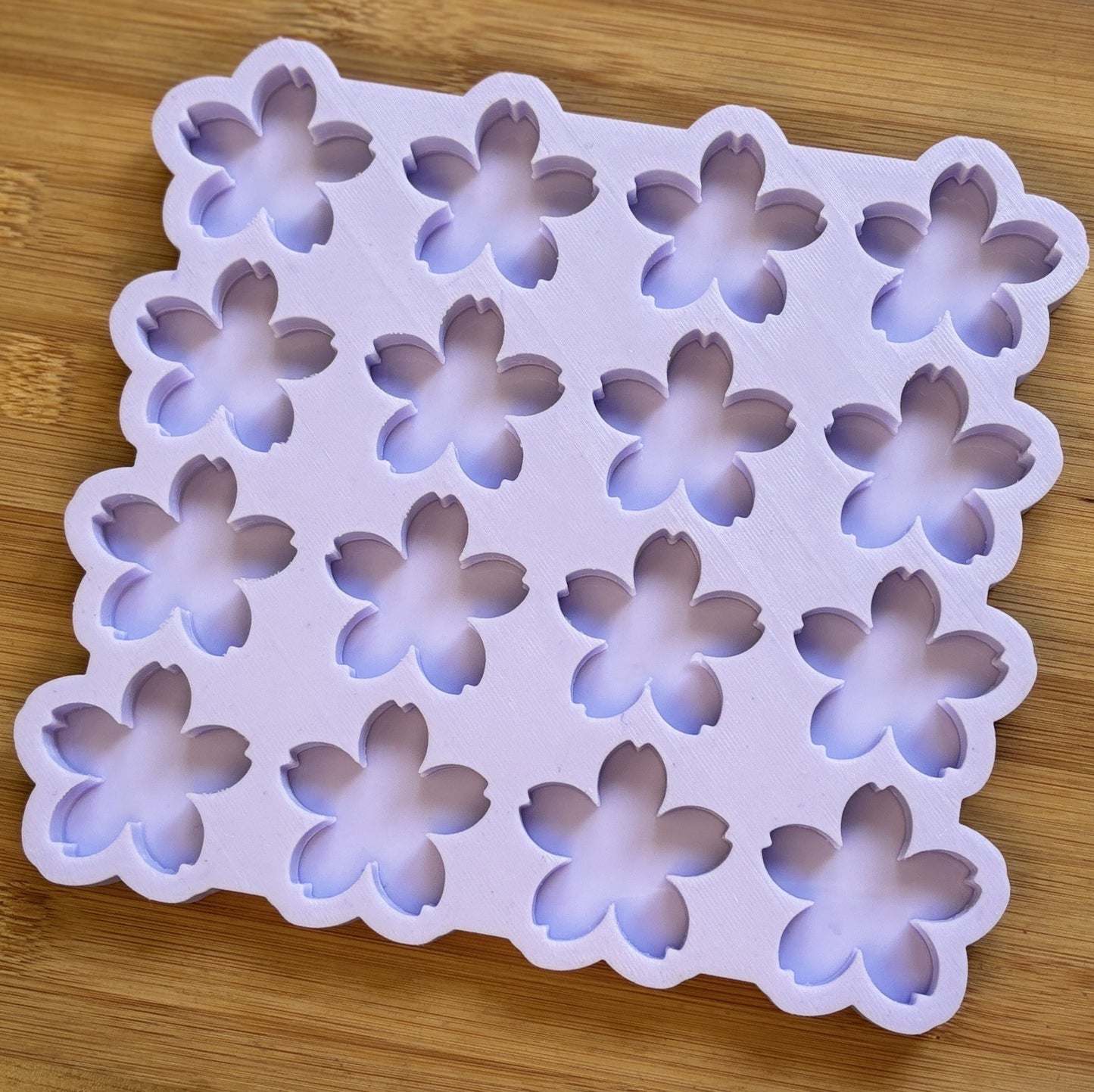 Flower-shaped silicone mold on a wooden surface