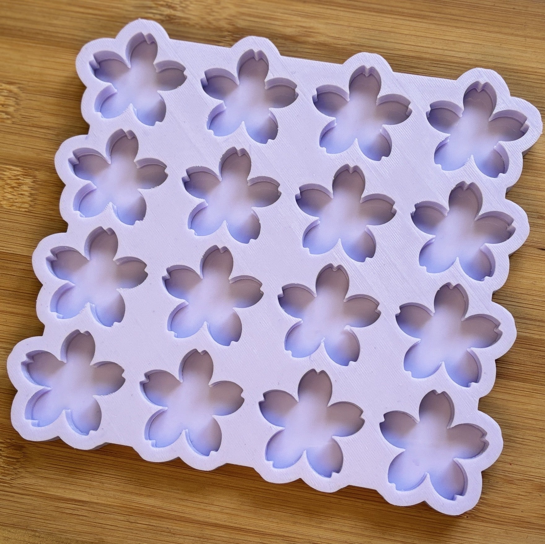 Flower-shaped silicone mold on a wooden surface