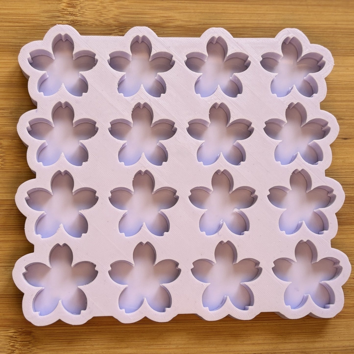 Flower-shaped silicone mold on a wooden surface