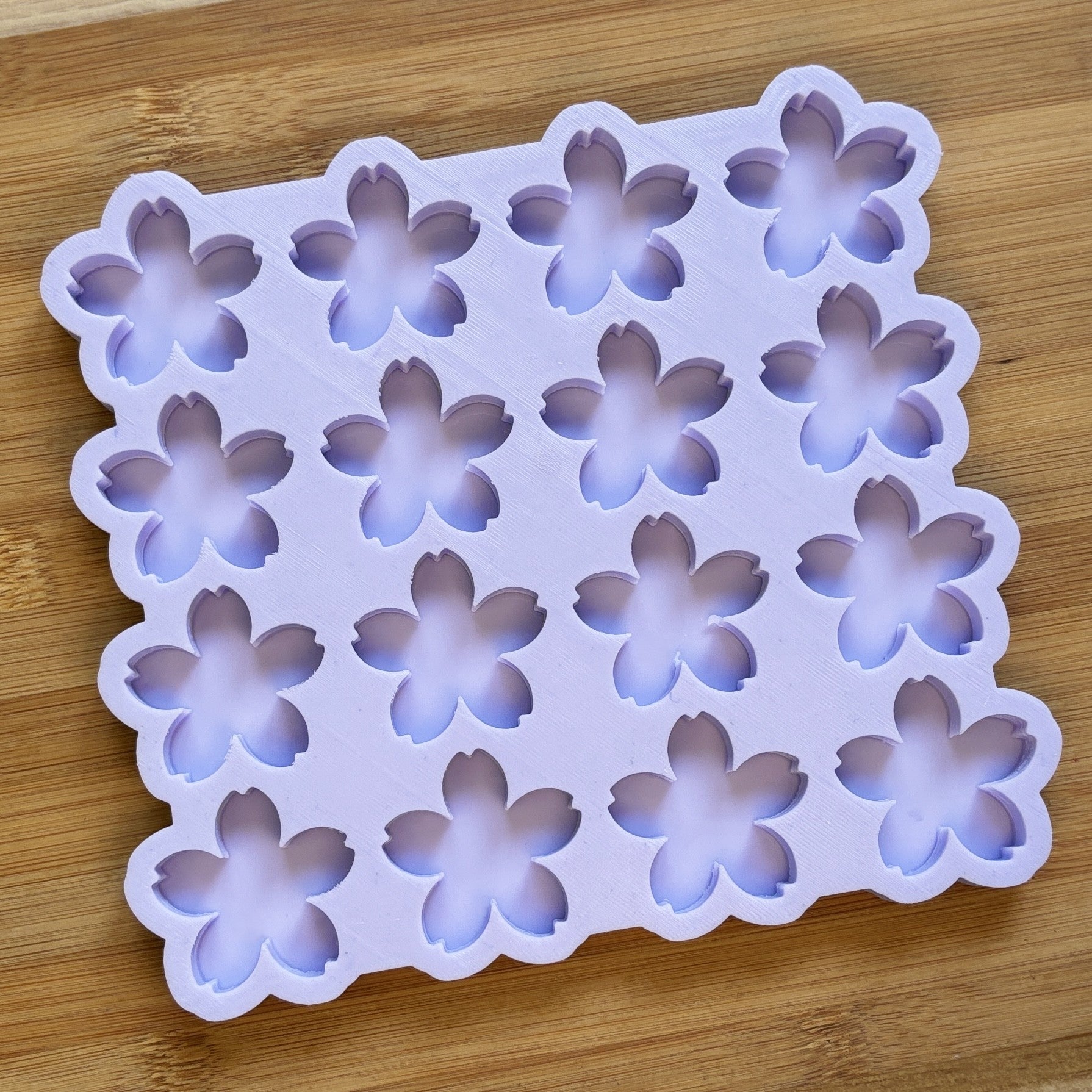 Flower-shaped silicone mold on a wooden surface