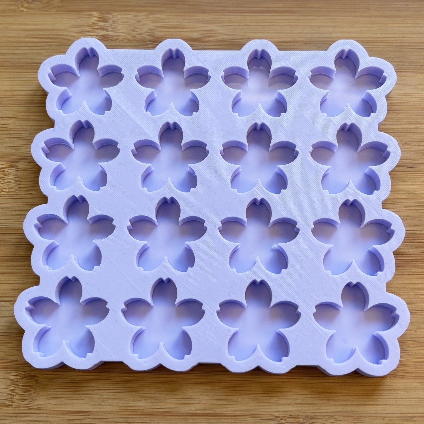 Silicone mold with flower shapes on a wooden surface