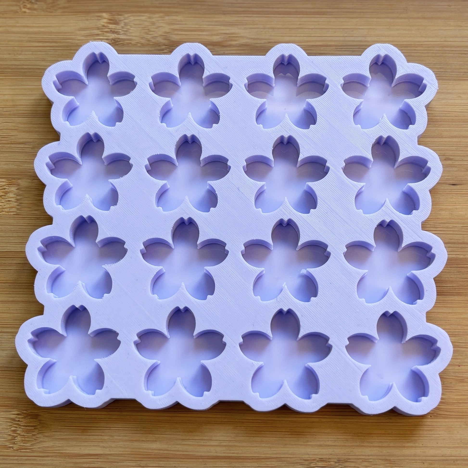 Silicone mold with flower shapes on a wooden surface