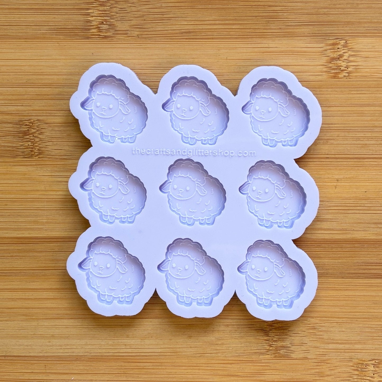 Sheep-shaped silicone mold on a wooden surface
