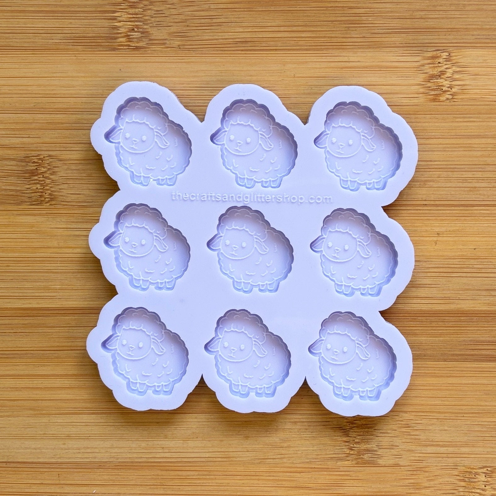 Sheep-shaped silicone mold on a wooden surface