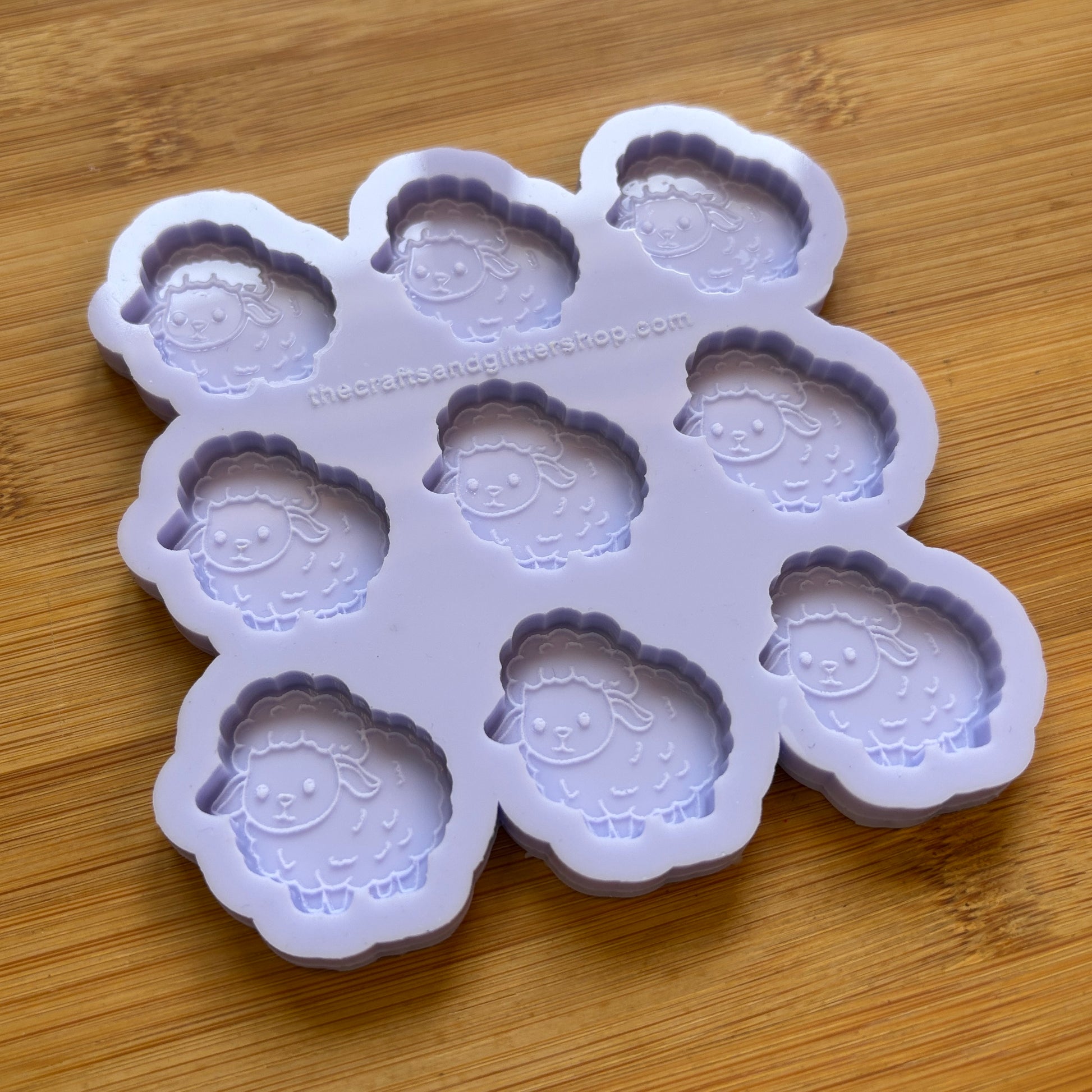 Sheep-shaped silicone mold on a wooden surface