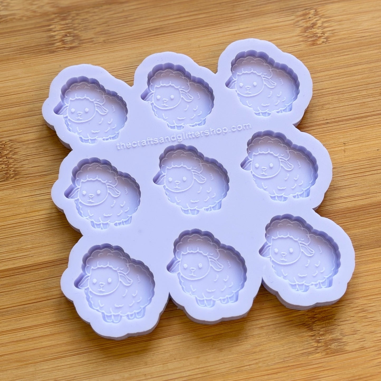 Sheep-shaped silicone mold on a wooden surface