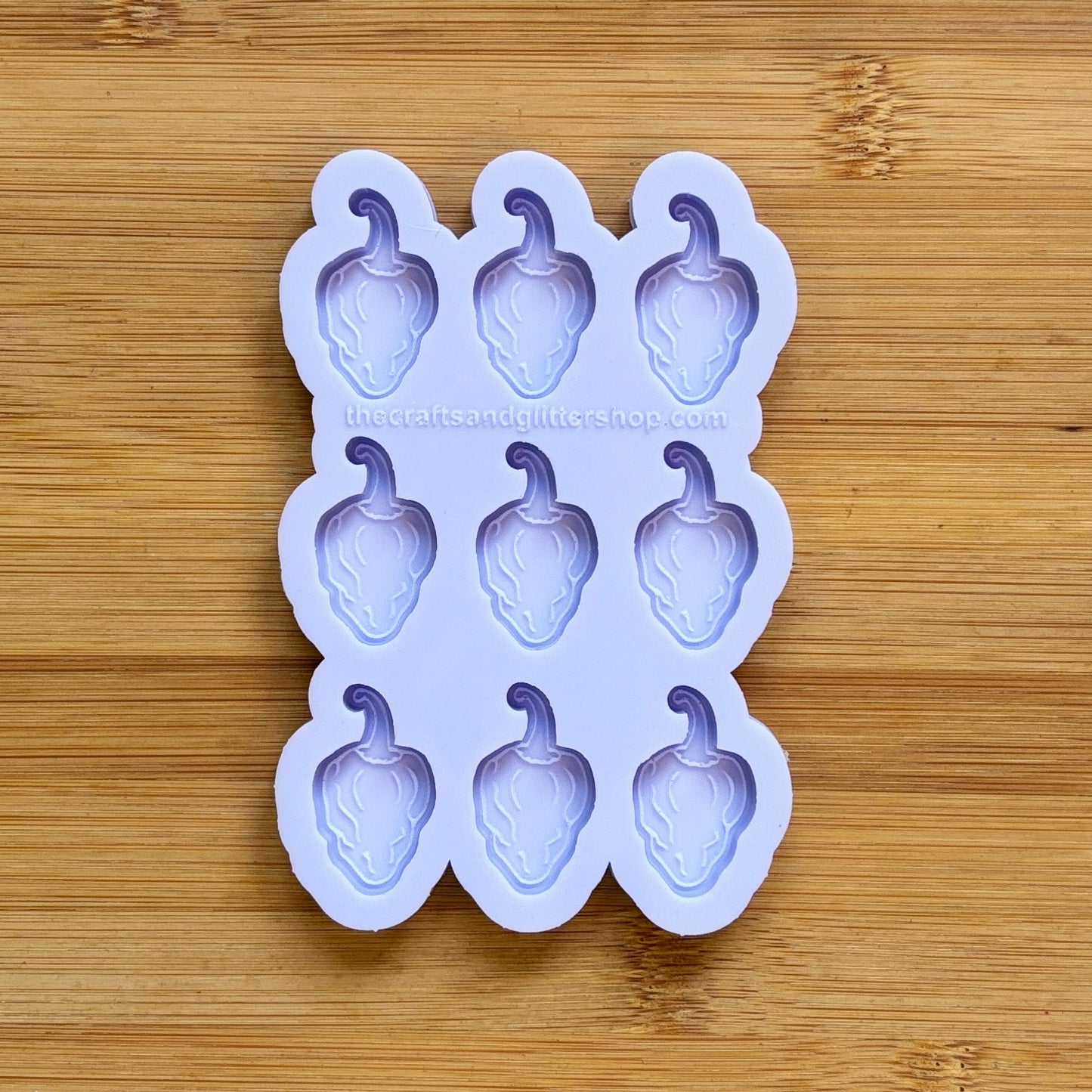 Silicone mold with habanero-shaped cavities on a wooden surface