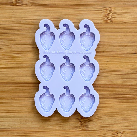 Silicone mold with habanero-shaped cavities on a wooden surface