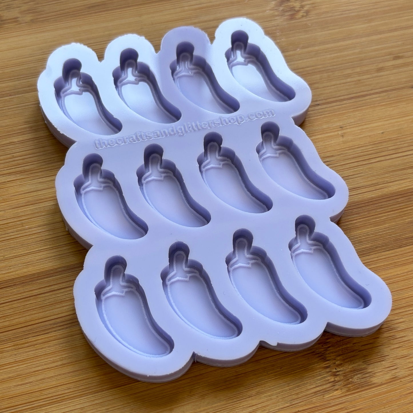 Silicone mold with jalapeno pepper shapes on a wooden surface
