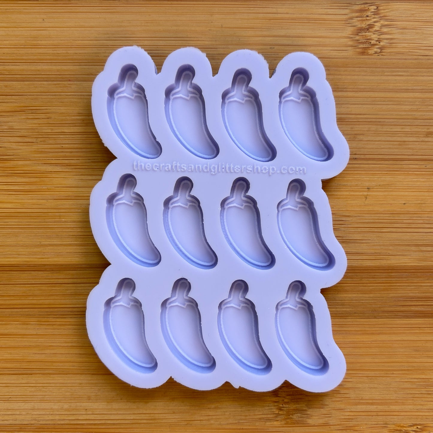 Silicone mold with jalapeno pepper shapes on a wooden surface