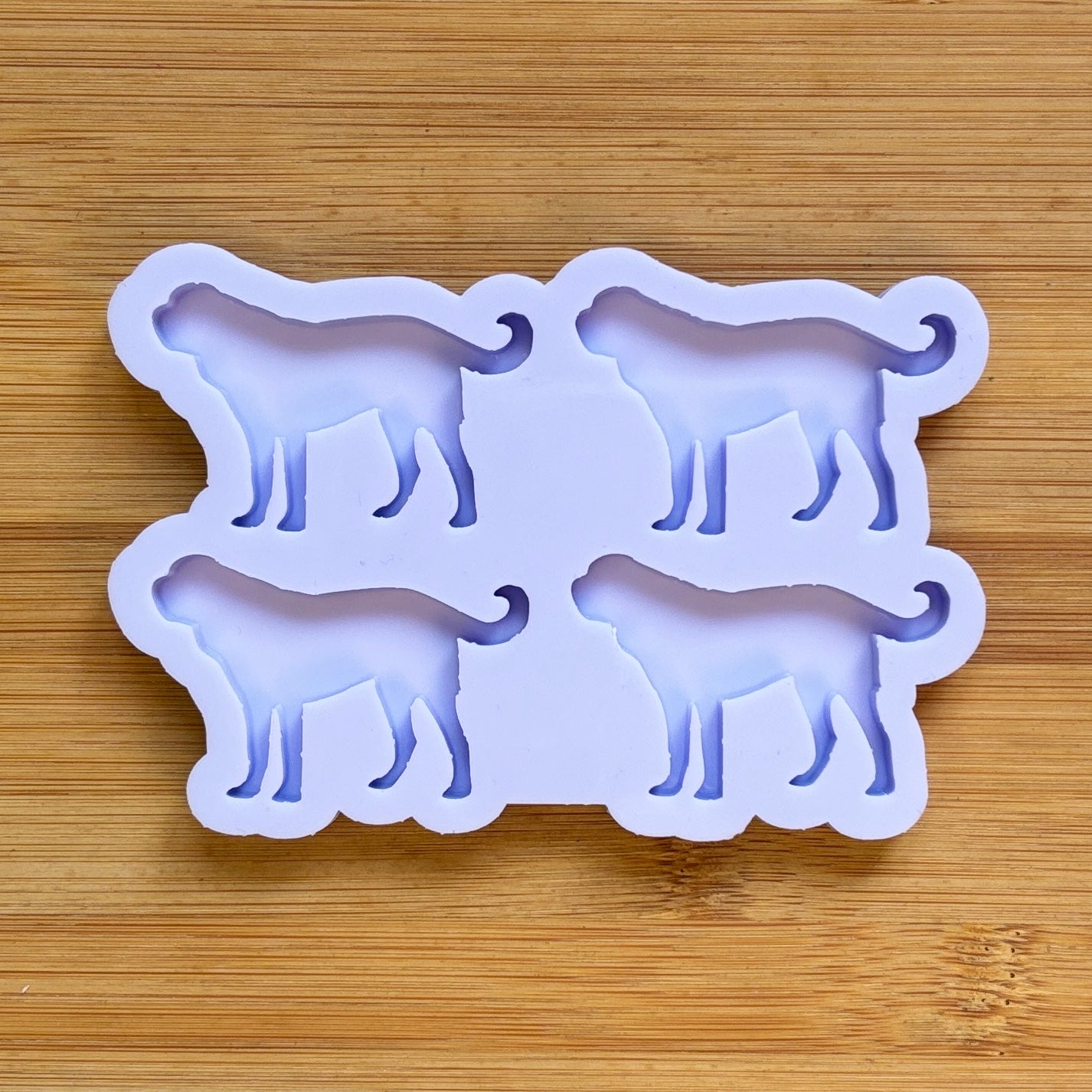 Silicone mold with dog shapes on a wooden surface
