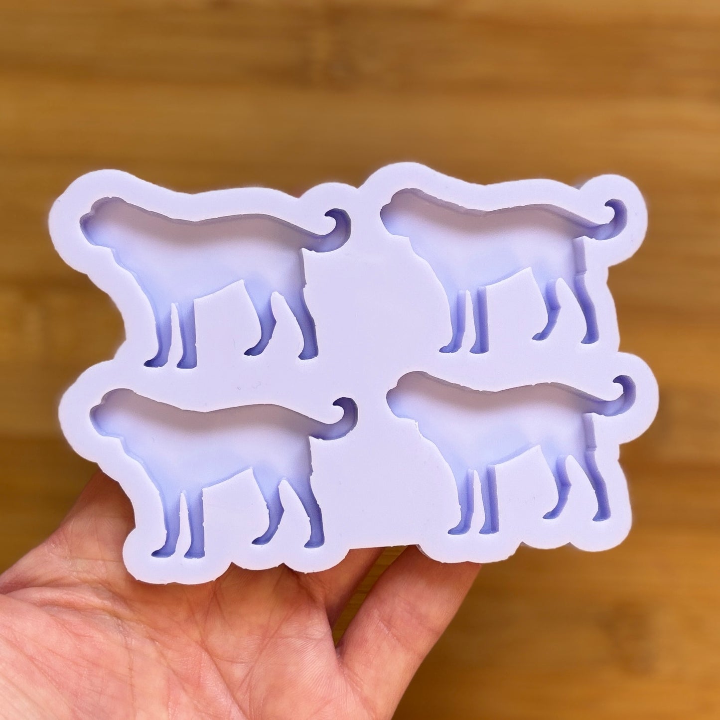 Silicone mold shaped like a dog on a wooden surface