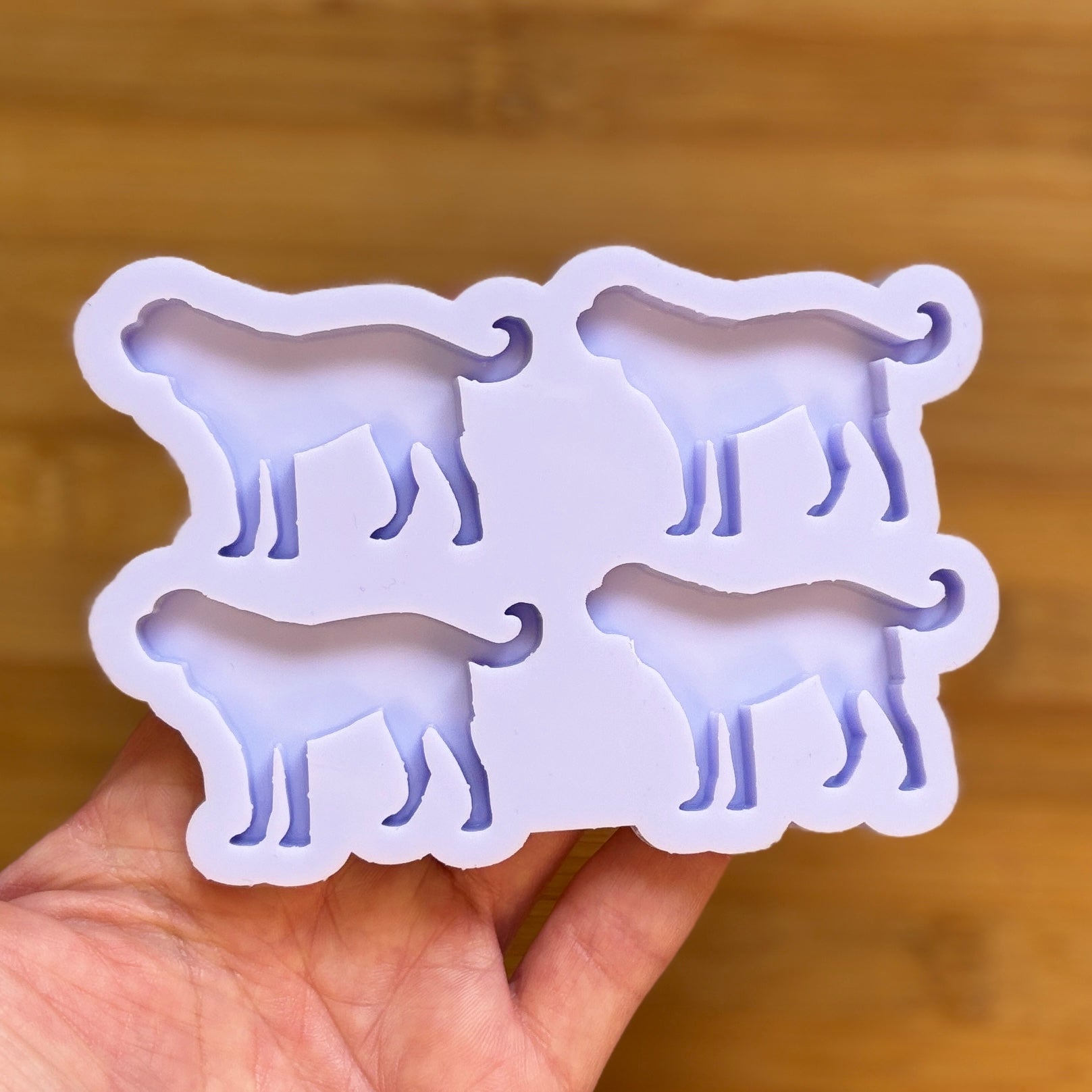 Silicone mold shaped like a dog on a wooden surface