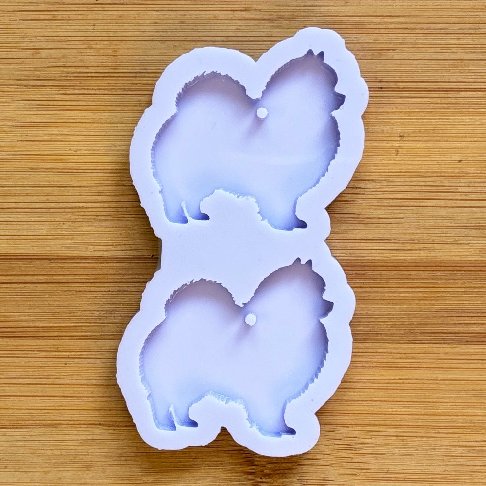 Silicone mold shaped like a dog on a wooden surface