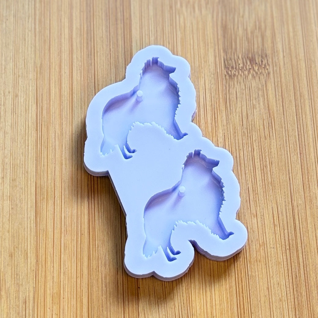 Silicone mold shaped like a dog on a wooden surface