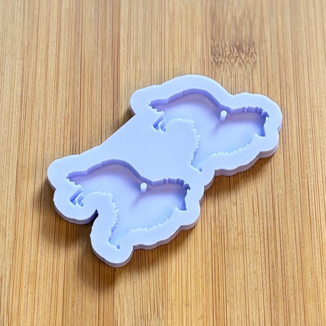 Silicone mold shaped like a dog on a wooden surface