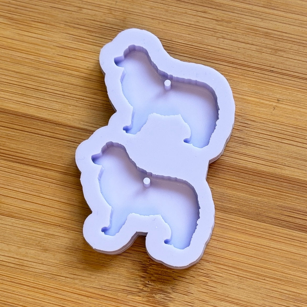 Silicone mold shaped like a dog on a wooden surface