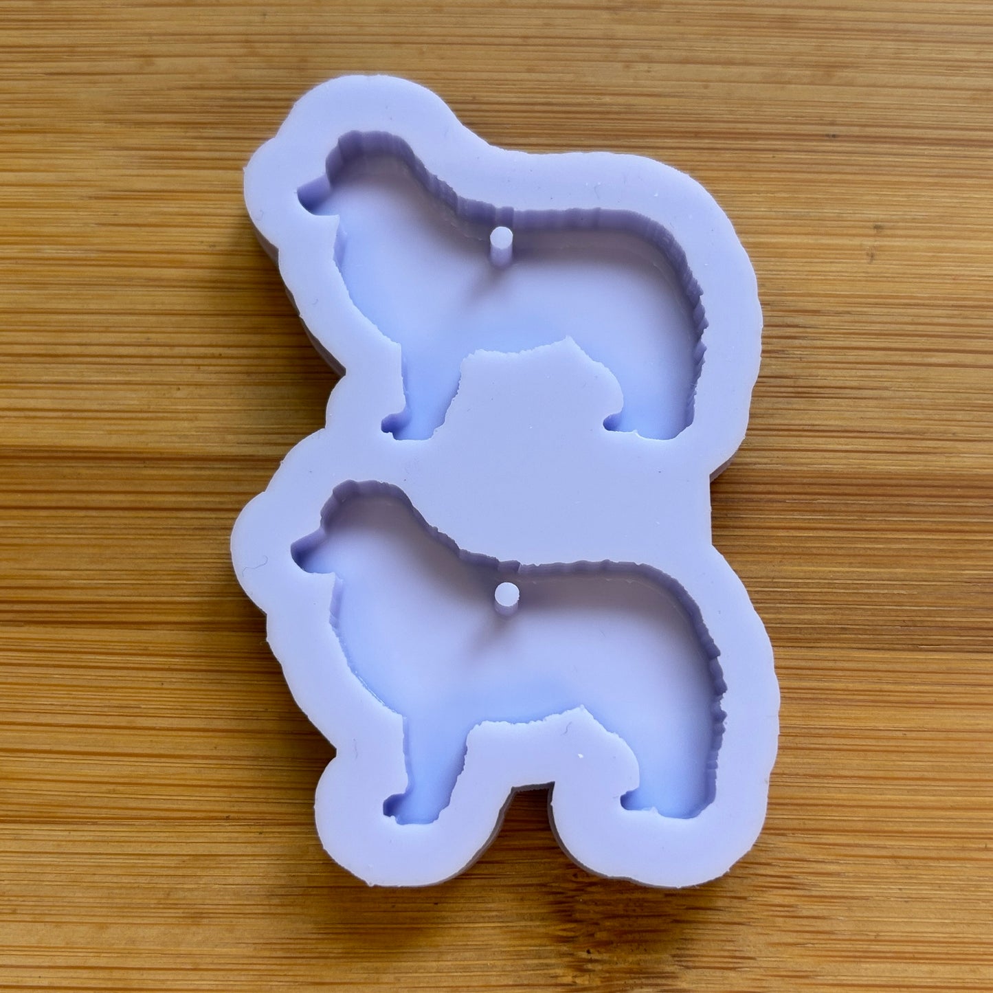 Silicone mold shaped like a dog on a wooden surface