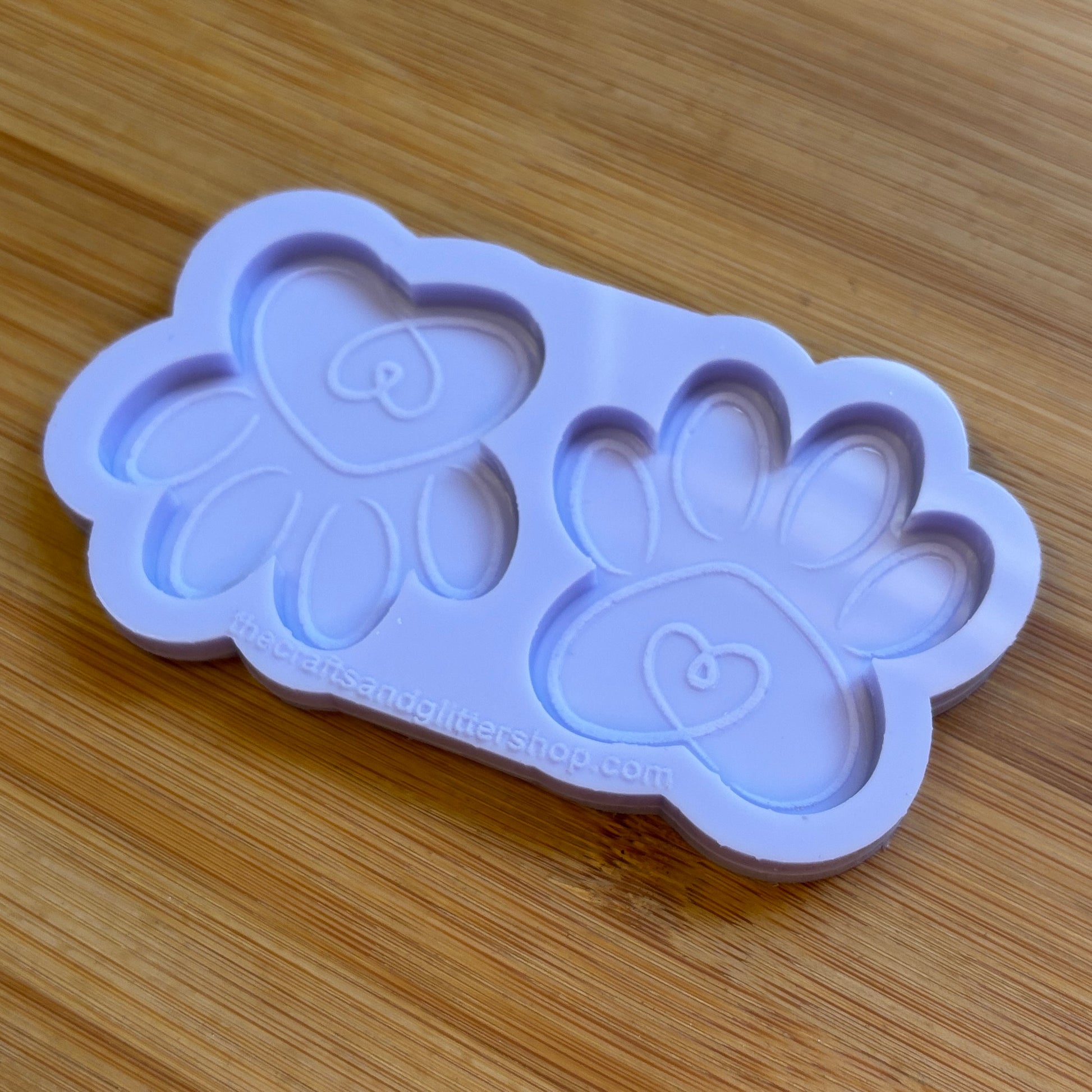 Silicone mold with paw prints on a wooden surface
