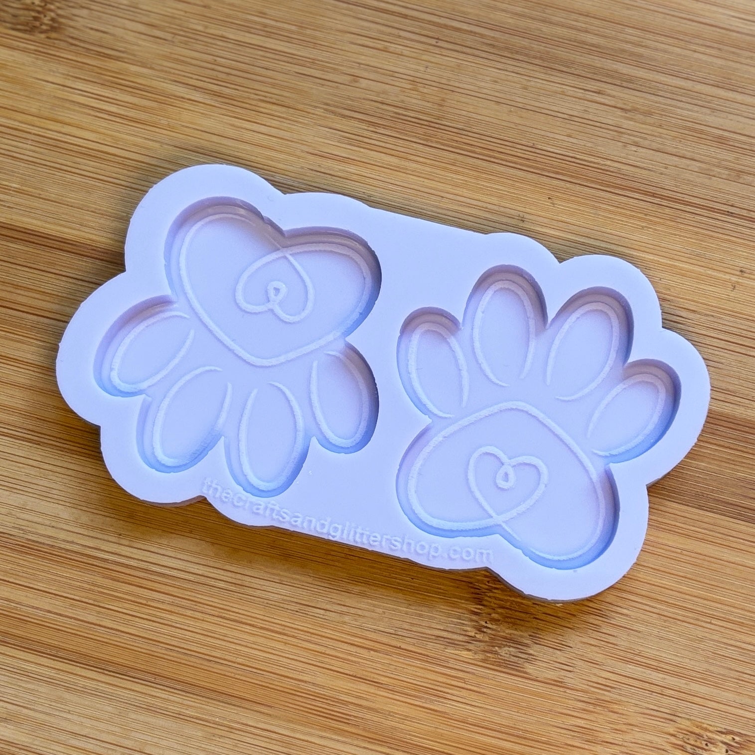 Silicone mold with paw prints on a wooden surface