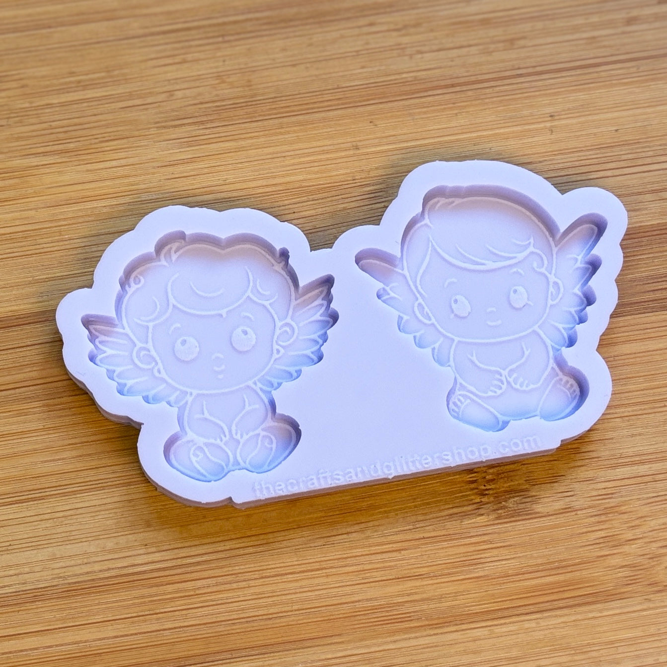 Silicone mold with angel design on a wooden surface