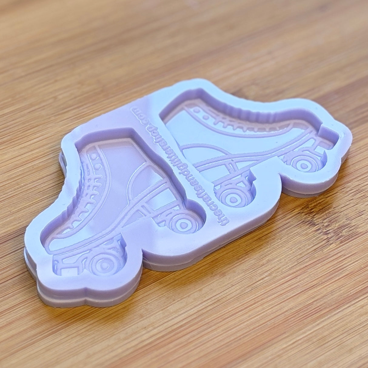 Purple roller skate-shaped mold on a wooden surface