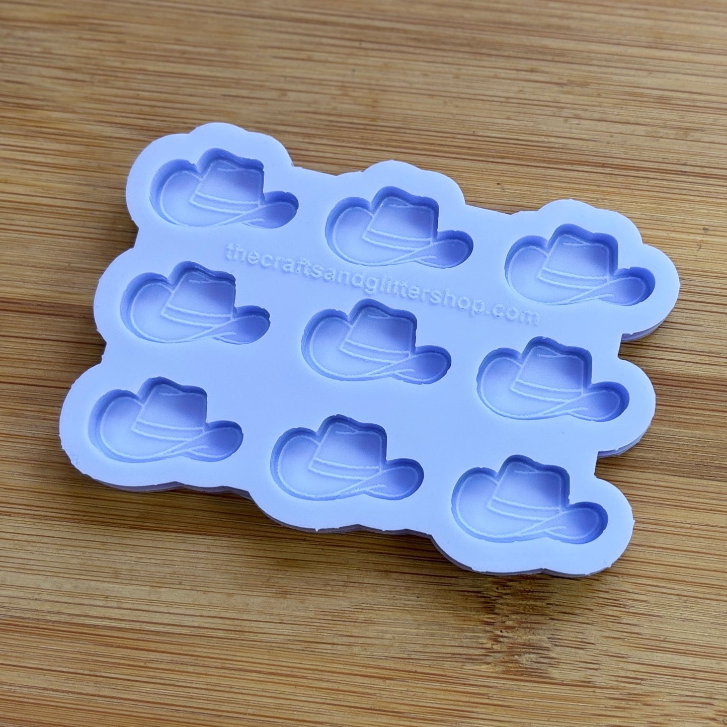 Silicone mold with cowboy hat shapes on a wooden surface