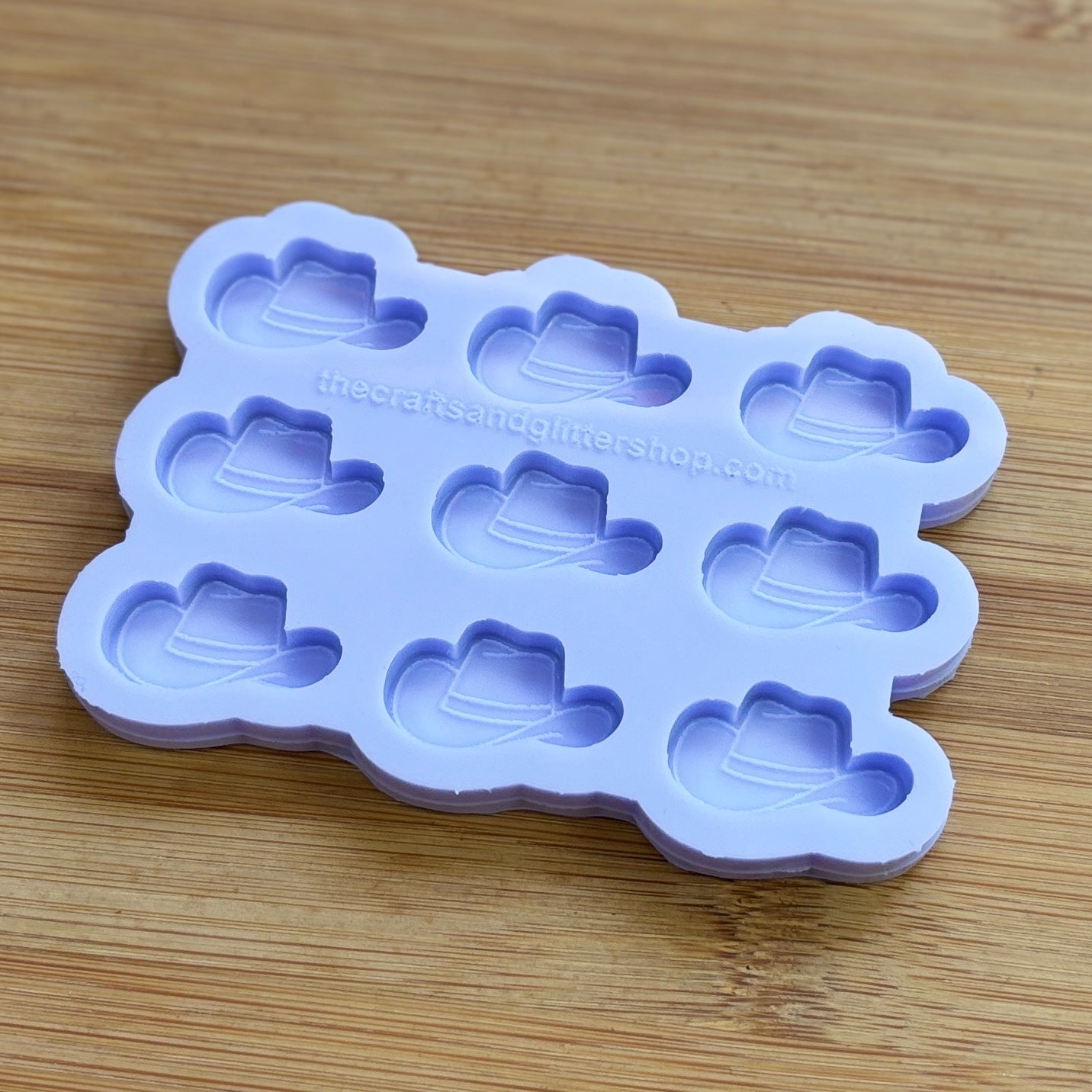 Silicone mold with cowboy hat shapes on a wooden surface