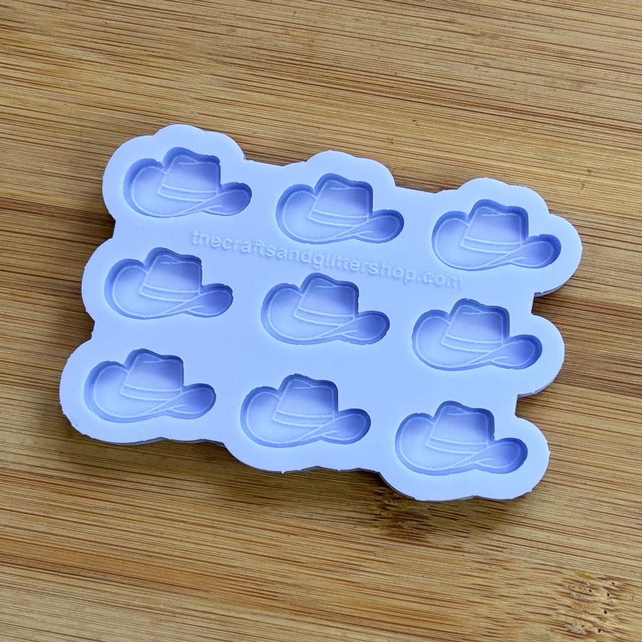 Silicone mold with cowboy hat shapes on a wooden surface