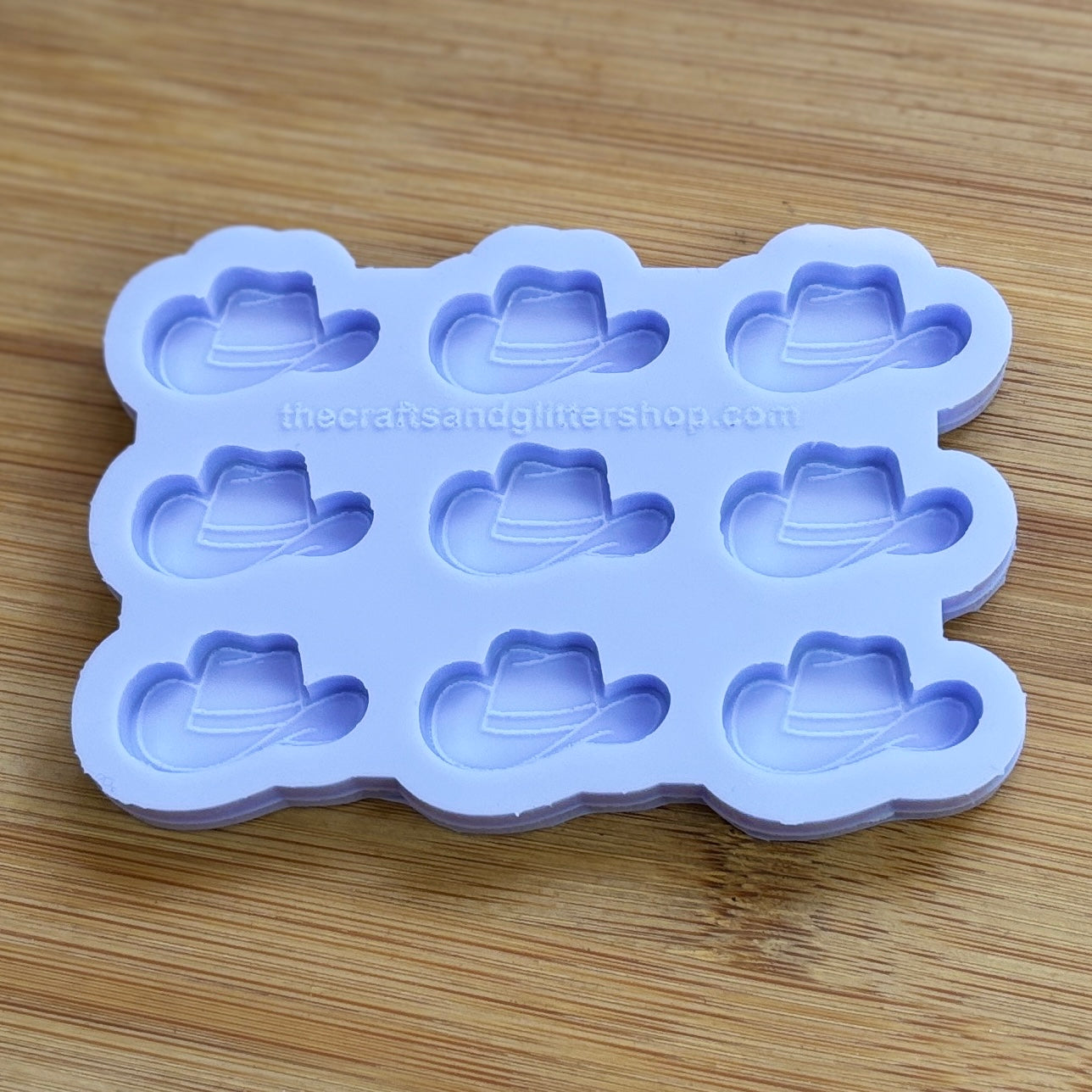 Silicone mold with cowboy hat shapes on a wooden surface